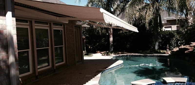 extended retractable awning overlooking a pool